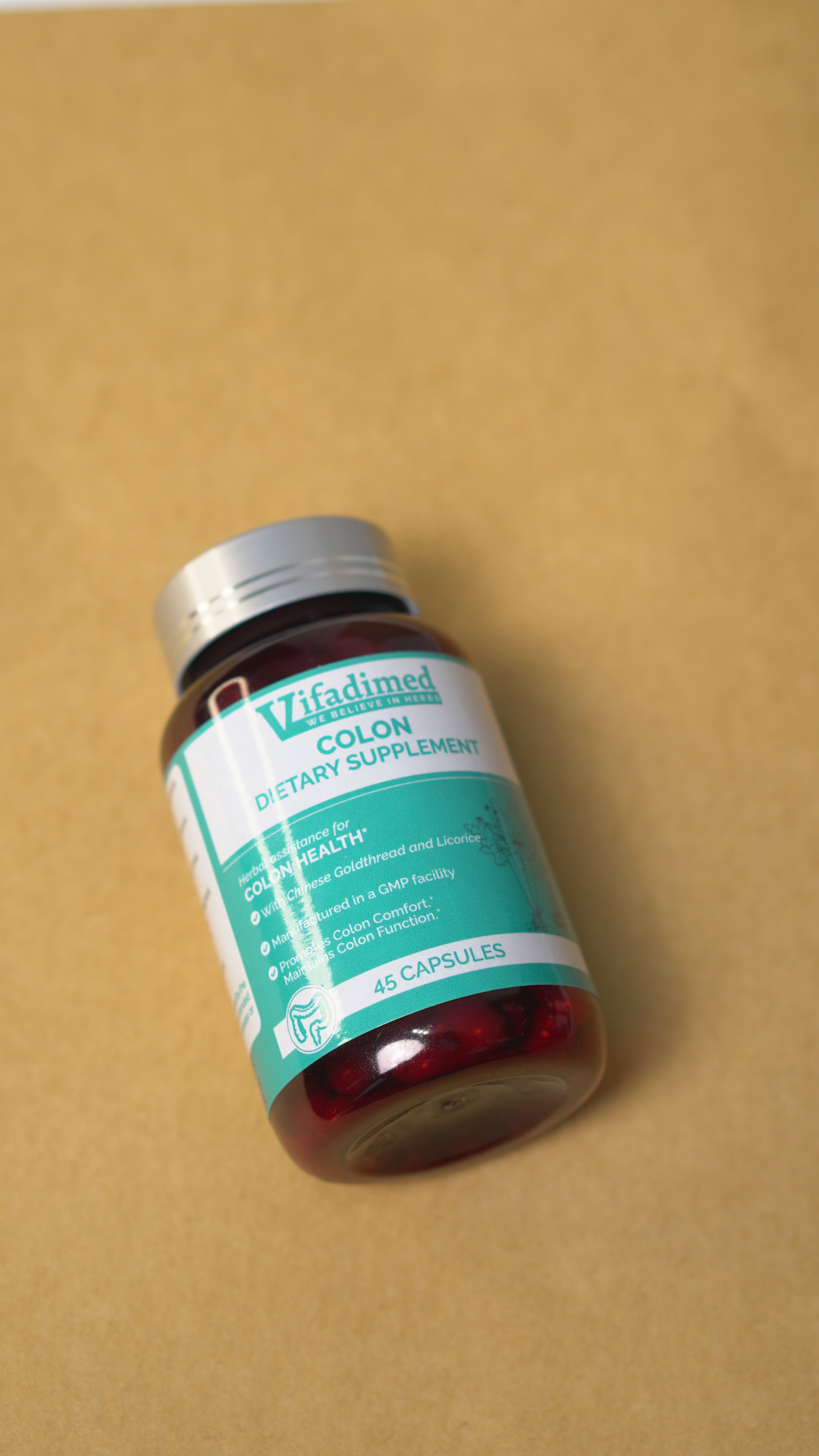 Medication bottle with a green label on a brown background