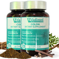 Two bottles of Vifadimed Colon dietary supplement capsules with natural elements in the background, such as herbs and a wooden cross.