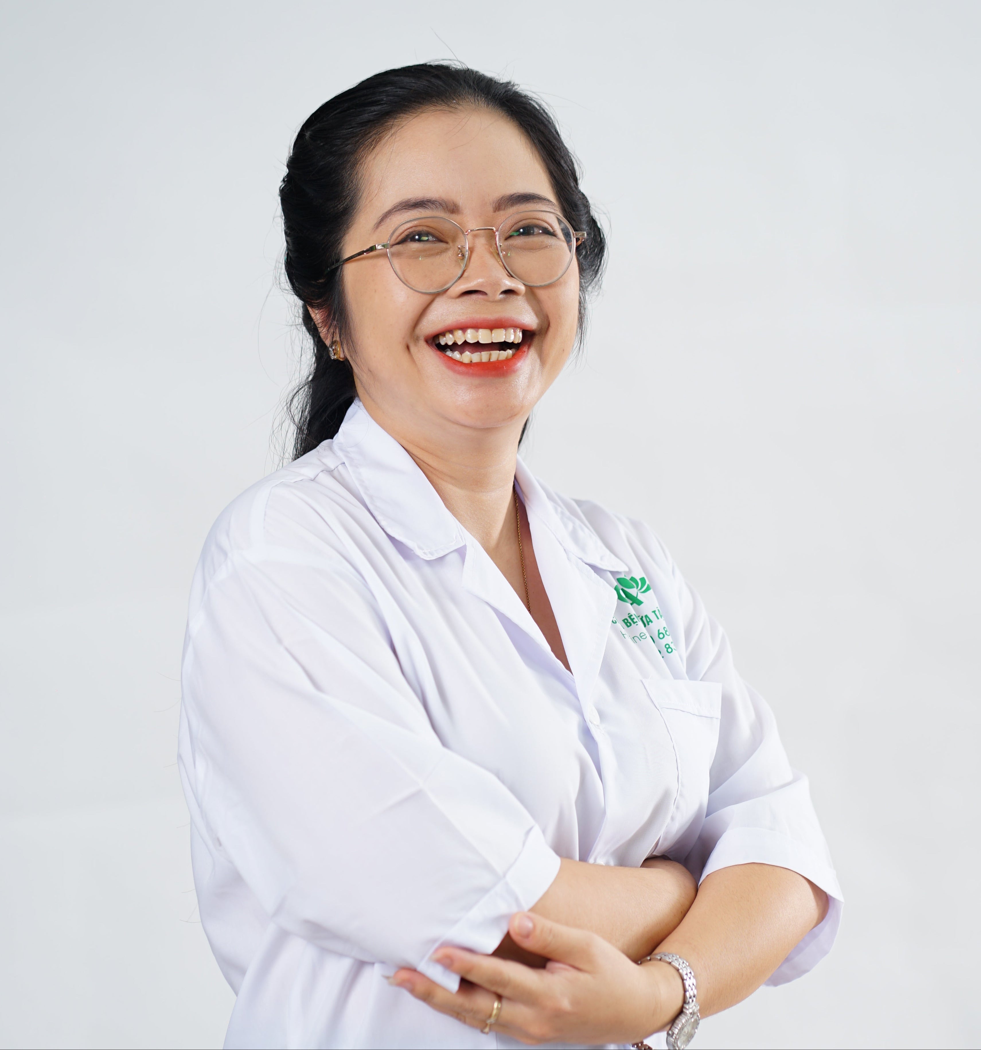 Person wearing a white shirt with a visible brand logo on a light gray background