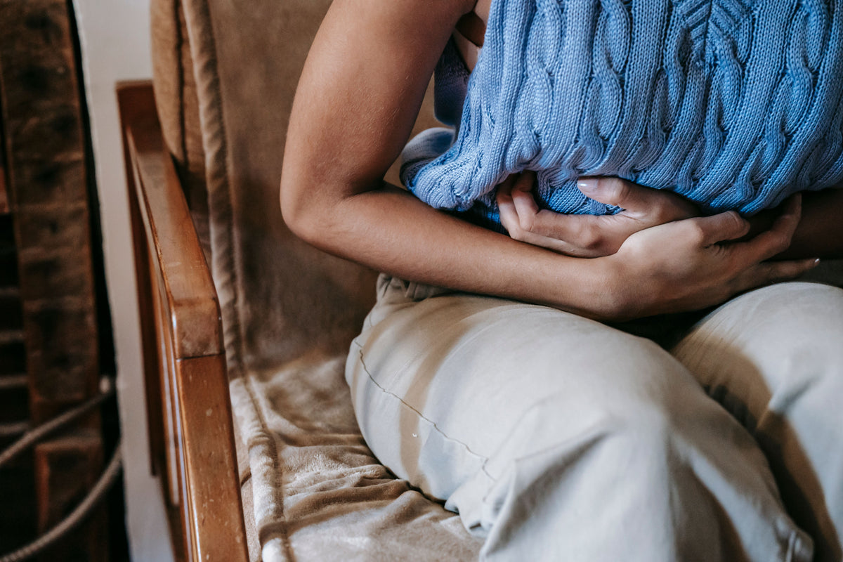 Person holding a blue blanket in a cozy indoor setting